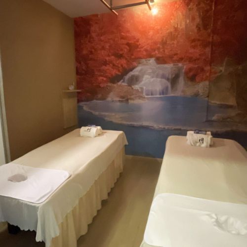Twin massage beds with a forest mural